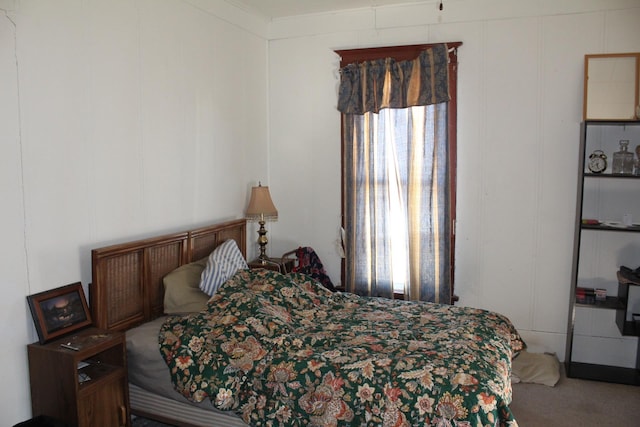 bedroom with light carpet and a decorative wall