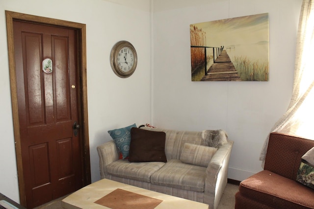 living area featuring carpet and baseboards