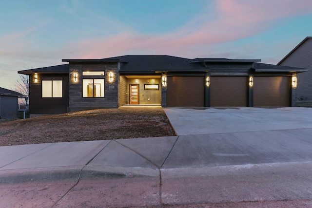 prairie-style house with concrete driveway and an attached garage