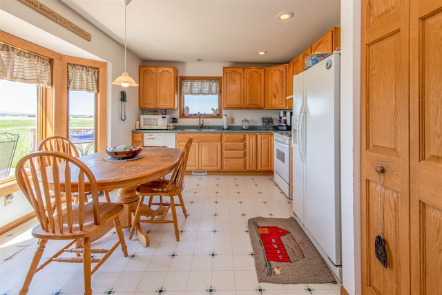 13220 N Haines Ave, Rapid City, SD 57701 - kitchen with white appliances, recessed lighting, light floors, a sink, and pendant lighting