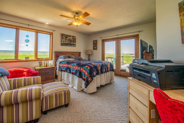 13220 N Haines Ave, Rapid City, SD 57701 - bedroom with a textured ceiling, a ceiling fan, access to exterior, carpet floors, and french doors