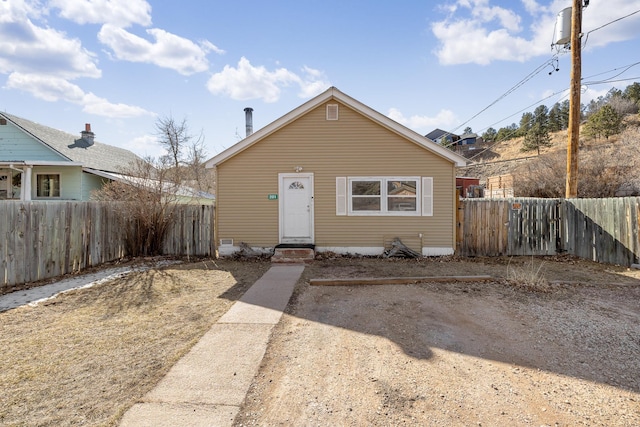 bungalow-style house with fence and entry steps