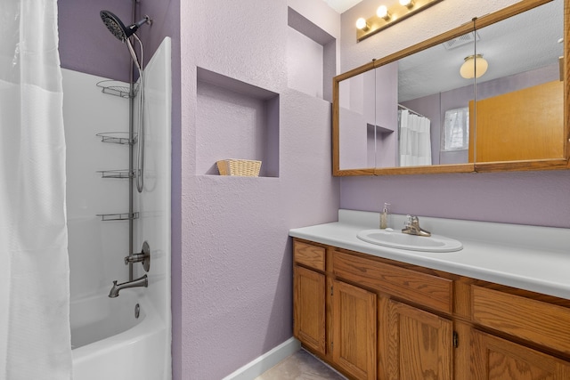 full bathroom with shower / bath combination with curtain, vanity, a textured wall, and visible vents