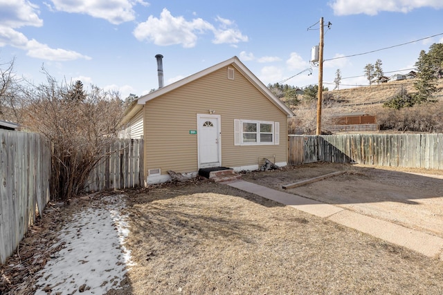 view of front of property featuring a fenced backyard and entry steps