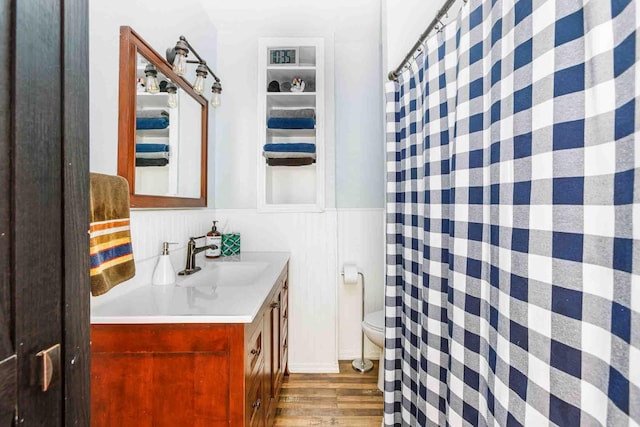 41 Taylor Ave, Deadwood, SD 57732 - full bathroom with a wainscoted wall, a shower with shower curtain, toilet, vanity, and wood finished floors