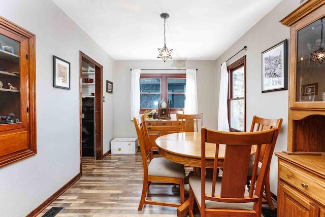 41 Taylor Ave, Deadwood, SD 57732 - dining area with a notable chandelier, baseboards, light wood finished floors, and visible vents