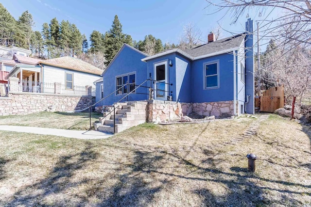 41 Taylor Ave, Deadwood, SD 57732 - view of front of property with stucco siding and a chimney