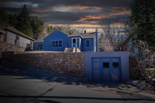 41 Taylor Ave, Deadwood, SD 57732 - ranch-style house with stucco siding, fence, driveway, a garage, and a chimney