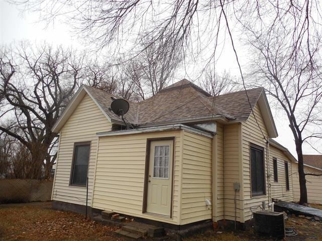 23508 Main St, Caputa, SD 57725 - view of side of home featuring central AC and roof with shingles