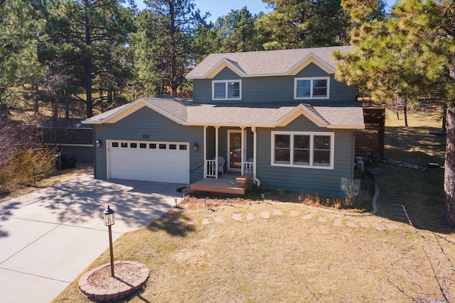 traditional home featuring an attached garage, a shingled roof, and concrete driveway