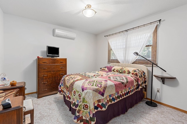 carpeted bedroom featuring a wall mounted AC, baseboards, and a textured ceiling