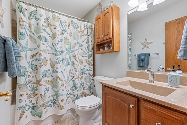 bathroom featuring toilet, shower / bath combo with shower curtain, and vanity