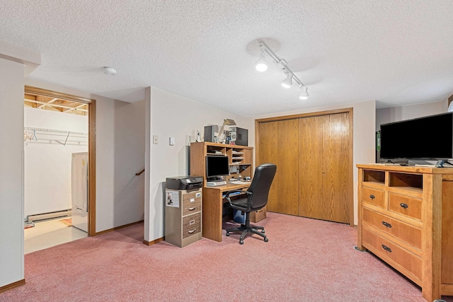 office area featuring carpet flooring, a textured ceiling, track lighting, baseboards, and a baseboard heating unit