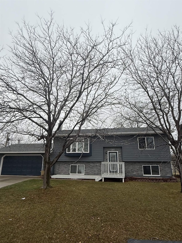 4809 Meadow Dr, Black Hawk, SD 57718 - bi-level home with driveway, an attached garage, and a front yard