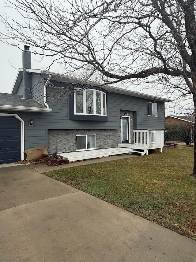 4809 Meadow Dr, Black Hawk, SD 57718 - raised ranch featuring a chimney, driveway, an attached garage, and a front lawn