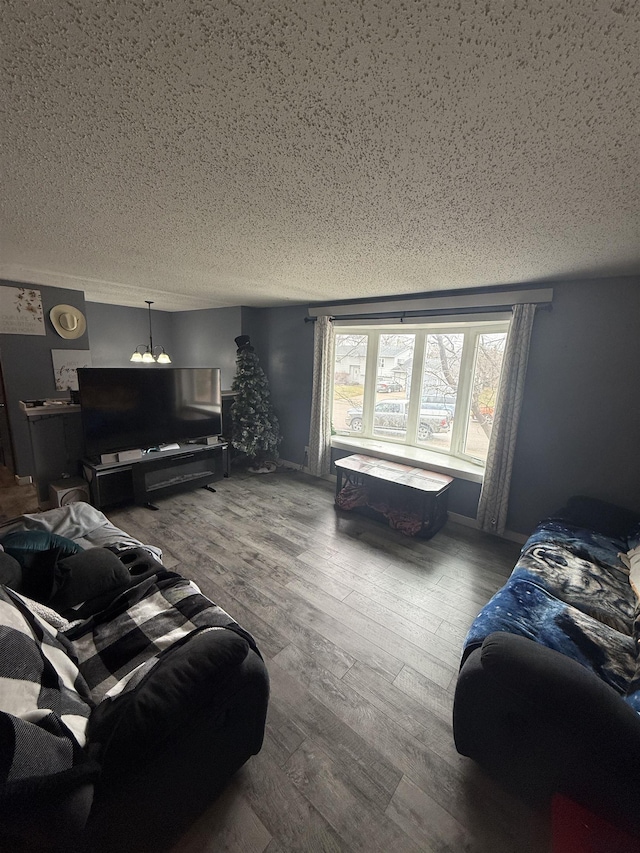 4809 Meadow Dr, Black Hawk, SD 57718 - living room featuring a notable chandelier, a textured ceiling, and wood finished floors