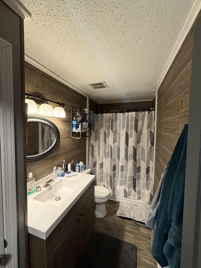 4809 Meadow Dr, Black Hawk, SD 57718 - full bath with vanity, wood walls, toilet, visible vents, and wood finished floors