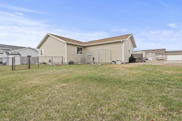 3370 Remington Rd, Rapid City, SD 57703 - rear view of property featuring a gate, central air condition unit, fence, and a lawn
