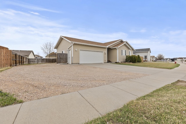 3370 Remington Rd, Rapid City, SD 57703 - view of front facade featuring a front lawn, driveway, fence, and a garage