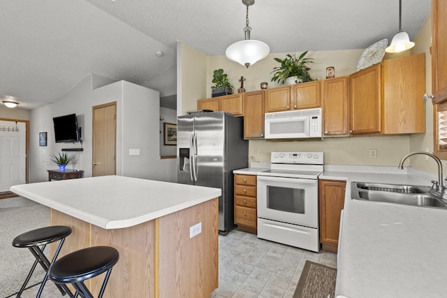 3370 Remington Rd, Rapid City, SD 57703 - kitchen featuring light countertops, white appliances, a kitchen island, lofted ceiling, and a sink