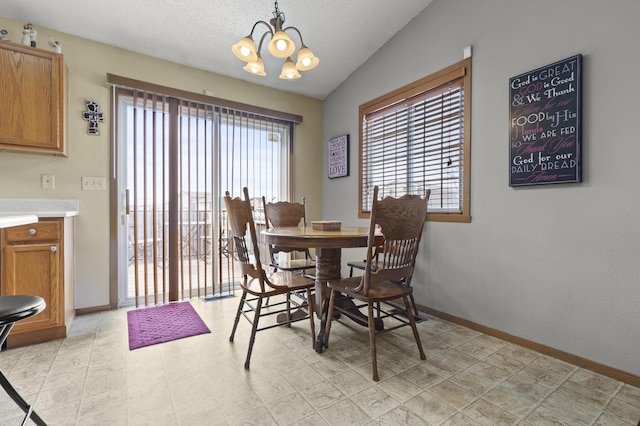 3370 Remington Rd, Rapid City, SD 57703 - dining area featuring baseboards, lofted ceiling, a chandelier, and a healthy amount of sunlight
