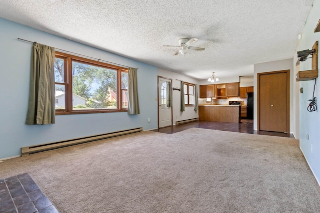 unfurnished living room with ceiling fan with notable chandelier, dark carpet, a baseboard heating unit, and a textured ceiling