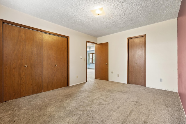 unfurnished bedroom with carpet flooring and a textured ceiling