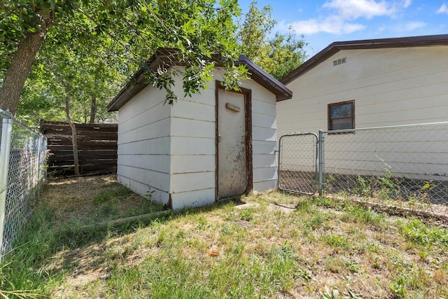 view of outbuilding featuring an outbuilding, a gate, and fence