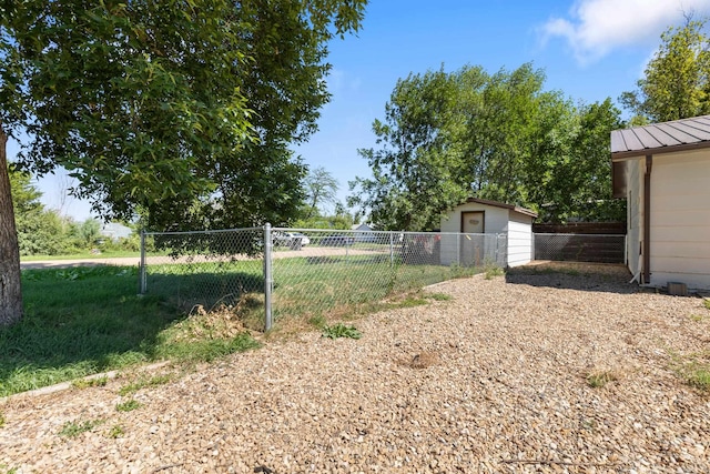 view of yard with an outbuilding and fence