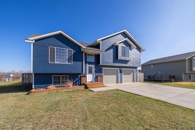 bi-level home featuring driveway, a front lawn, fence, and an attached garage