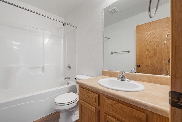 bathroom featuring toilet, vanity, washtub / shower combination, and visible vents