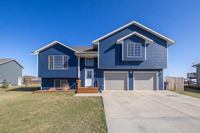 raised ranch featuring a front lawn, fence, driveway, and a garage