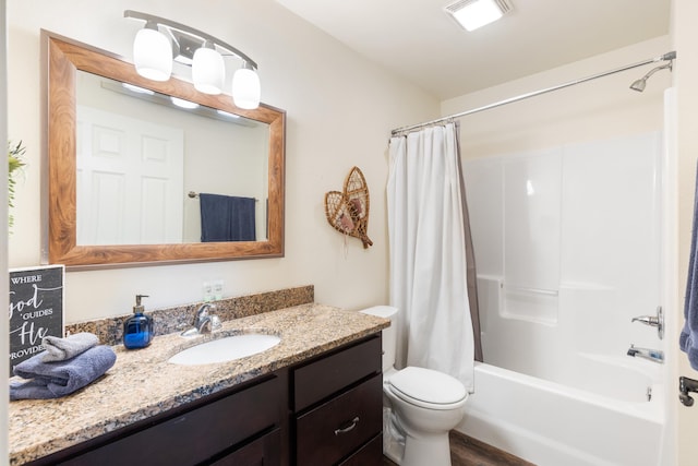 bathroom featuring visible vents, toilet, shower / bath combo with shower curtain, and vanity