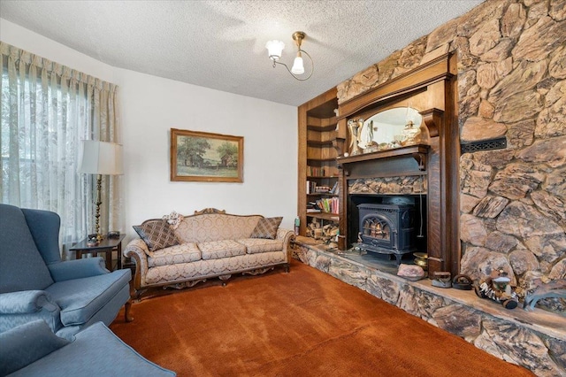living room featuring a wood stove, carpet flooring, and a textured ceiling