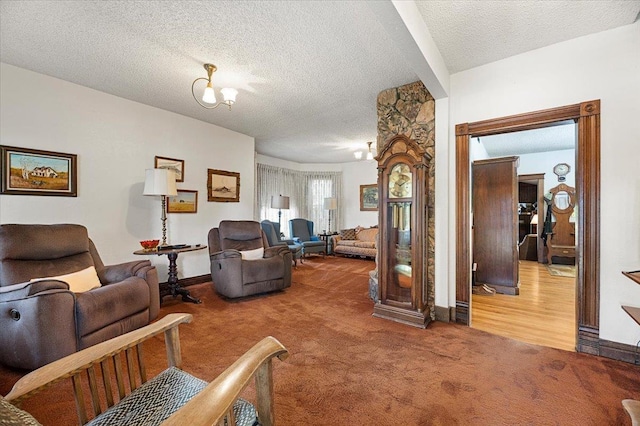 living room with a textured ceiling, carpet flooring, and baseboards