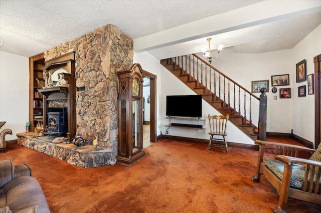 carpeted living room featuring a textured ceiling, an inviting chandelier, baseboards, and stairs
