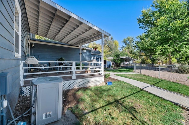 view of side of home featuring a yard and fence