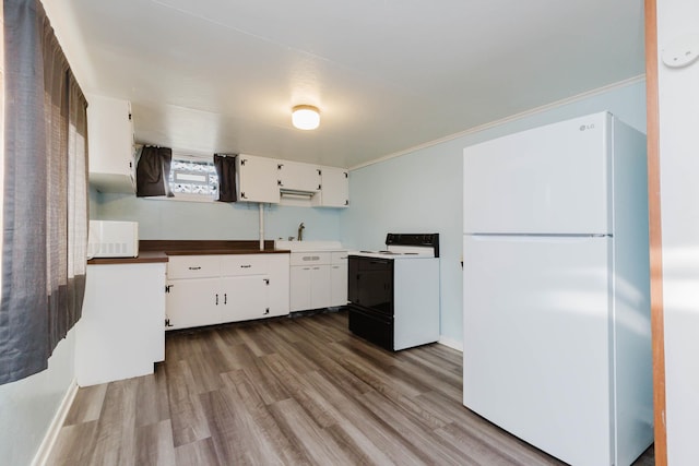 1227 S Street, Rapid City, SD 57701 - kitchen with white appliances, ornamental molding, white cabinetry, wood finished floors, and a sink