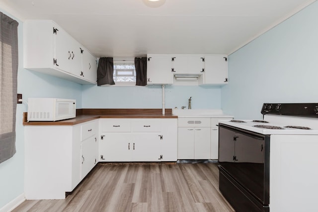 1227 S Street, Rapid City, SD 57701 - kitchen featuring light wood-style flooring, white microwave, white cabinetry, and electric range oven