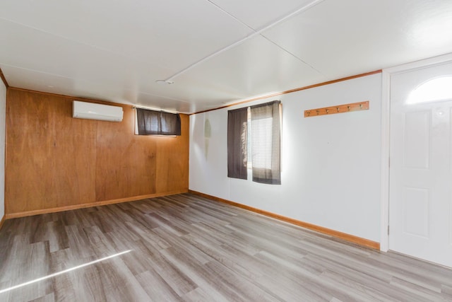 1227 S Street, Rapid City, SD 57701 - finished basement with baseboards, a wall unit AC, and wood finished floors