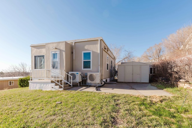 1227 S Street, Rapid City, SD 57701 - back of house with a storage shed, ac unit, a yard, and an outdoor structure