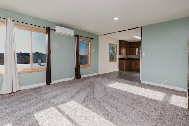1227 S Street, Rapid City, SD 57701 - unfurnished living room with recessed lighting, carpet, an AC wall unit, and baseboards