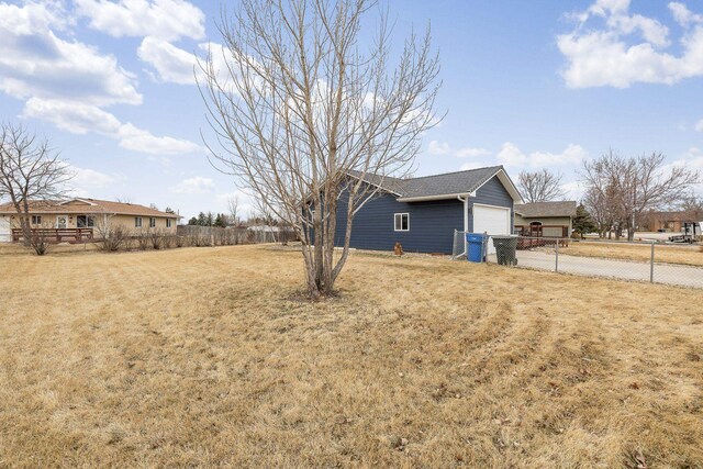 1914 7th Ave, Belle Fourche, SD 57717 - view of yard with an attached garage, fence, and driveway