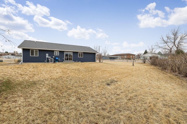 1914 7th Ave, Belle Fourche, SD 57717 - back of property with a yard and roof with shingles