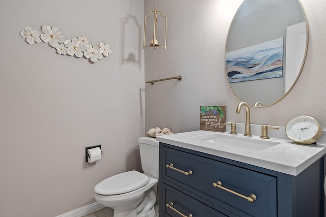 half bath featuring toilet and vanity