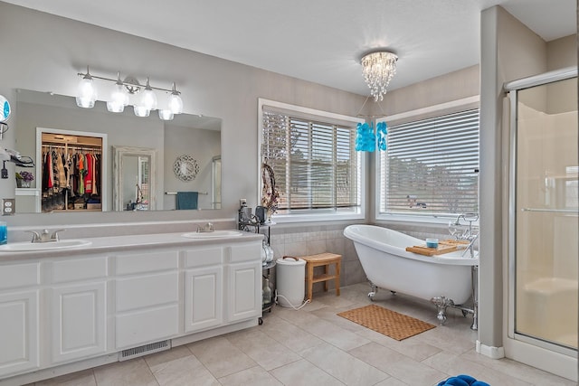 full bath with a shower stall, visible vents, tile patterned flooring, and a sink