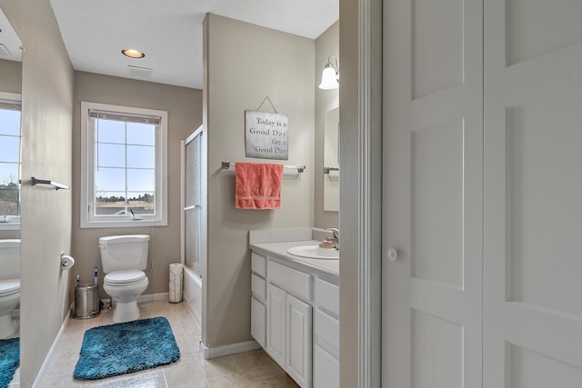 full bathroom featuring vanity, bath / shower combo with glass door, baseboards, toilet, and tile patterned flooring