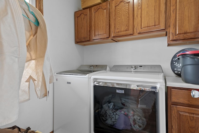laundry room with cabinet space and independent washer and dryer