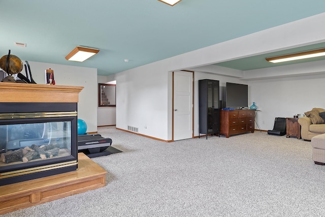 living area with carpet, visible vents, and baseboards