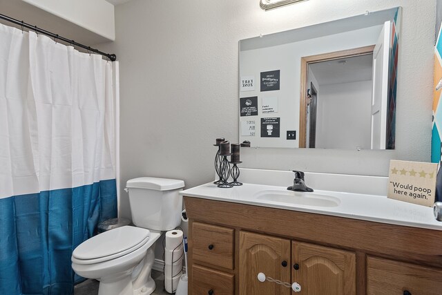 full bathroom with vanity, a shower with shower curtain, and toilet